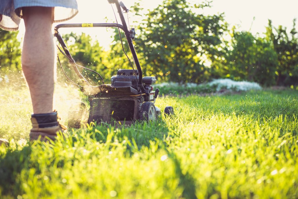 Photo of a person mowing the lawn by Magic K | Pexels
