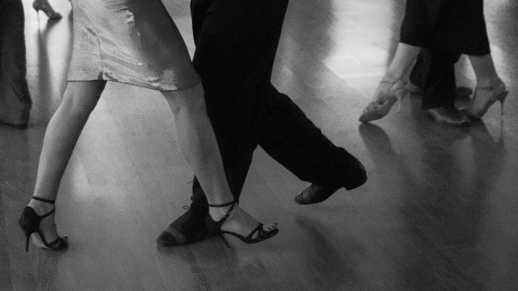 Photo of close-up view of legs and feet of people dancing by Christian Harb | Unsplash