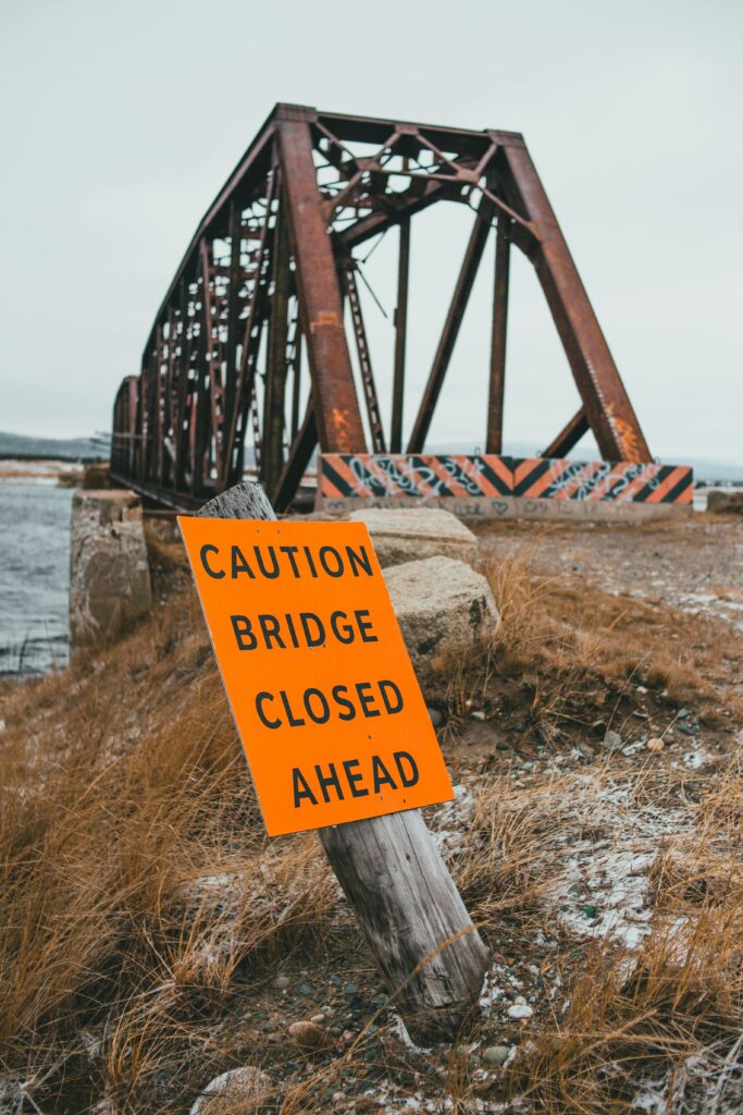 Photo of bridge closed warning sign near bridge over river by Erik Mclean | Pexels